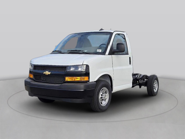Passenger-side view of the Chevrolet cutaway chassis cab interior showing gray cloth bucket seats