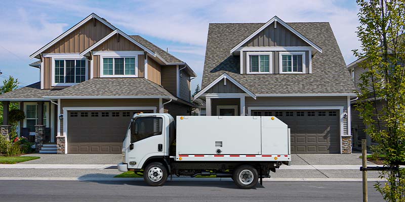 White Chevrolet medium-duty service utility truck parked in a residential neighborhood