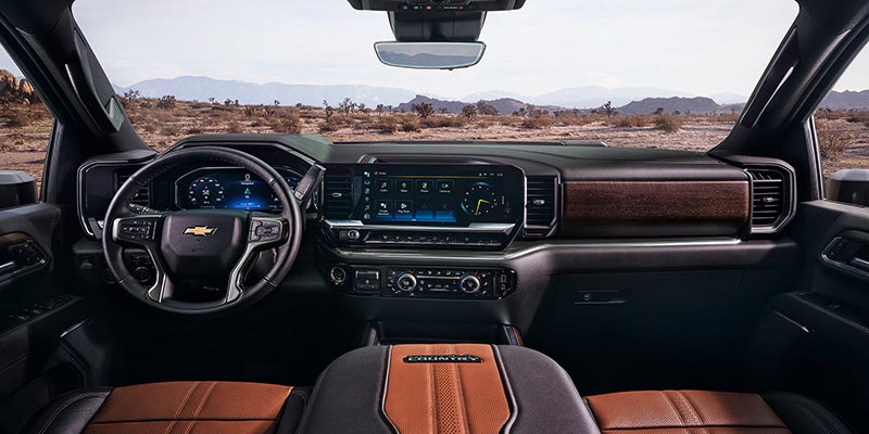 Interior view of a Chevrolet Silverado HD showing the dashboard, digital displays